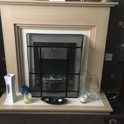 Electric fire and hearth mantelpiece surround. As new, only used a few times. Very warm heat output