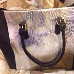 Black and silver
Lovely bag.
Never used
£35 in sale originally