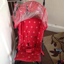 Red and pink dot pushchair with rain cover and basket needs a clean