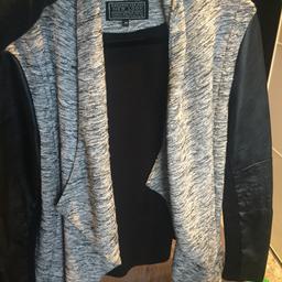 Grey marl material with black stretchy leather PU arms in excellent condition, size 14 from new look 

SMOKE FREE HOME
