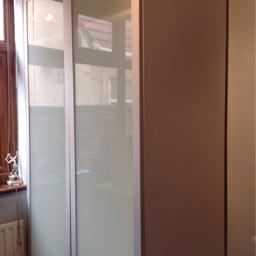 White wardrobe. White frosted glass doors. One top shelf and one bottom shelf. 
dimensions: w100 h200 d60
