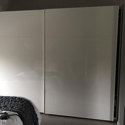 We are selling our IKEA white gloss sliding wardrobe. Each side is 1.5 metres wide and s total width is 3 m . Let me know if you need exact to the cm. Height is 2m37cm.
Amazing amount of storage and is kitted out the same on each side with trouser hangers, shoe storage, hanger space, tie/scarf holders, glass shelf, 5 drawers each side. Over 1000 new. Great condition. Please get in touch with any questions. Still currently assembled.
