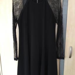 This dress is a lovely swing dress with lace sleeve detail.. Only worn once and in excellent condition..