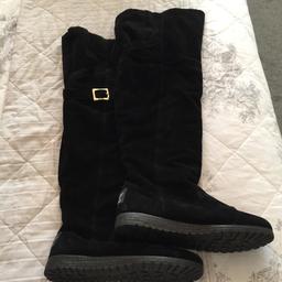 A black suede pair of over the knee boots from River Island. Flat, size 6. Buckle detail, fur lined, can be turned over for additional feature. Excellent condition.