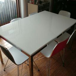 Gloss white 1400 x 850 IKEA table with chrome legs and frame. 6 designer gloss white with art deco backs in red, black and silver. All are in mint condition with no damage. Table worth £160 and chairs £75 each. Selling entire set of table and 6 chairs for £150.00