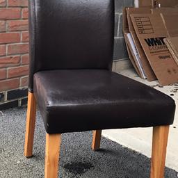 Set of 4 faux leather brown chairs with wooden legs.