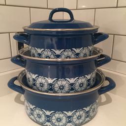 Very good condition only small signs of wear. Deep teal blue with white flowers. Oven to hob. Large pan to rim 9 1/2 cm height and 22cm diameter, medium 9cm , 20 1/2cm and small 8 1/2 18cm very retro yet still modern