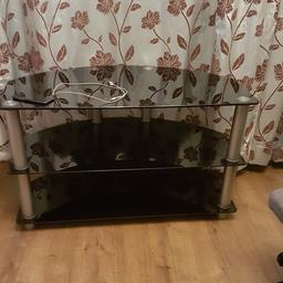Its good condition black glass stand with three shelves. 49" tv can b place on it.