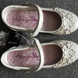 Brand new with tags never been worn children's size 12 girls party shoes creamy white colour beautiful butterfly details. Smoke and pet free home.