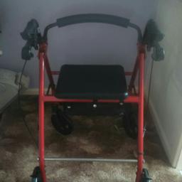 Red and black 
Mobility Walker with soft seat 
And foot bar and  shopping basket
In excellent condition
