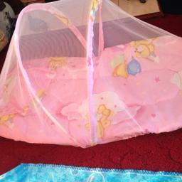 Lightly padded cushion bottom with tiny pillow and net to protect baby. Folds down for travel. Never used.