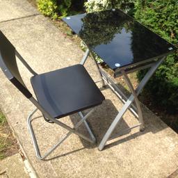 Table has black glass top. And silver frame. Chair is foldable .
Sorry no offers so offers will be ignored to save time