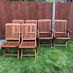 6 garden chairs complete with cushions, two with arms. Very rarely used. Been brushed down but photos show wood fading. If varnished would come up well. All locking mechanisms checked.