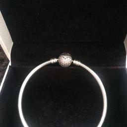 Beautiful and excellent condition genuine pandora bangle size 17 cm. with pink diamond heart.                              Item can be post with extra charge ( signed for delivery ) and pay via PayPal as friends and family.   Pay via PayPal as goods will be charge for fee. Thank you