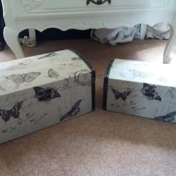 Here I have are a pair of butterfly trunket boxes covered in a fabric material in good condition.