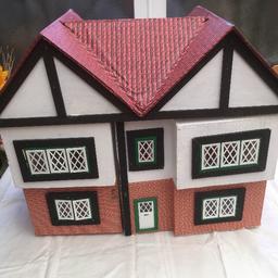 Wooden dolls house with furniture and people