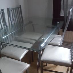 Glass dining table and 6 chairs glass has some age related scratches chair covers recently removed and washed and covered with protective covers some seats need screwing back in but screws all present very strong great buy