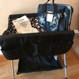 This has pocket for storing everything you need to change your baby. It folds up to give you more room. It has the instructions as well