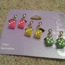 Three pairs of coloured clip on earring dice. Label removed however original packaging.  Never been worn.