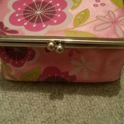 Fabric floral pattern make up bag. Mirror in roof of bag on the inside.