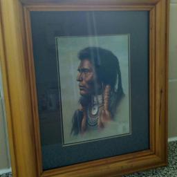 A classic wooden framed picture of a traditional Native American Warrior.