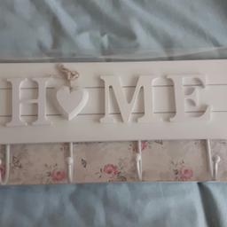 Brand new, unused. Wooden HOME plaque and metal painted hooks. Beautiful item.
