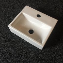 Small sink suitable for cloakroom or small bathroom. Bought for ours but turned out too big. Selling for half what we paid. Dimensions are 33cm wide. 28 cm deep and 10cm tall.