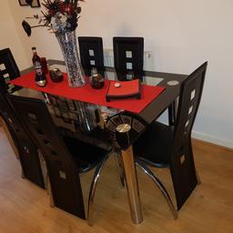 Glass dining table and 6 chairs with matching coffee table both in good condition. Can deliver locally
