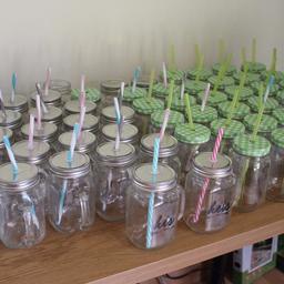 Mason jar drinks glasses that are perfect for parties, gatherings or DIY weddings.

2 his and hers glasses for the bride and groom.
25 with handles, lids and straws.
33 with lids and straws.
A couple more without lids.

All washed and ready to go.