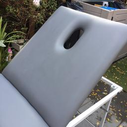 A grey massage bed with face hole . Folds neatly easy to transport. Good quality, good all round condition. Slight mark from a cleaning product see photo .