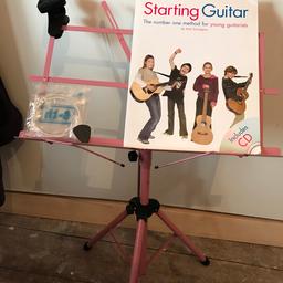 Pink music stand 
Complete wit:
Guitar learning to play book
Strings 
Guitar string tuner 
Guitar cover and stand bag