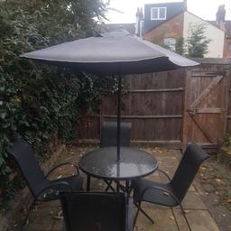Used garden furniture with chairs and umbrella. In good condition. A bargain