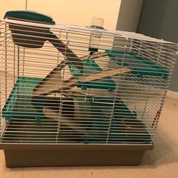 Multi level hamster cage with water bottle, bowl and wheel. 
Some of the ladders have been chewed but still can be used.
