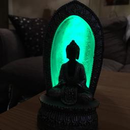 Multi coloured light change Buddha ornament.