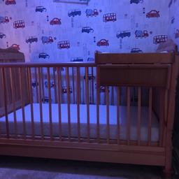 Solid wood cot which also converts into a bed never slept in comes complete with mattress never slept on also changing table which can slide from side to side 
Cot has been disassembled ready to collect
Just has slight marks which are from putting toys in ect