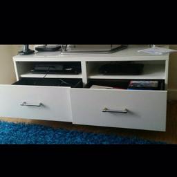 Ikea TV stand with 2 shelves,  2 large drawers and glass top it's in good condition gloss. Had it for 6 months. Selling this because I am redecorating my house.

Other items on the picture not included , only tv stand .