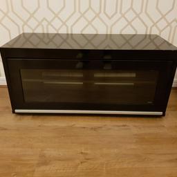 Black tv stand by TECKLINK.
I purchased this from Mayfair.co.uk for £279.

This is In good condition. It's very heavy and robust. The door slides up and in very modern and yet an elegant. Selling as I'm redecorating the lounge.

110 cm