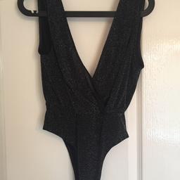 Brand new with tags ladies black glitter cross over low cut bodysuit
Size 10

Excellent condition, from a pet and smoke free home.
Happy to post at the expense of the buyer.