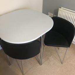 Dining table with chairs in great condition, around a year old with minimal use. Chairs fit completely under table so good space saver.

The table is white with chrome legs (76cm tall x 84cm x 84cm). 

The chairs are black leather effect with chrome legs. Small mark on the back on one of the chairs reflected in price.

COLLECTION ONLY - Croydon/Thornton Heath.