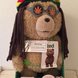 Talking ‘Ted’ 16” bear in Rasta outfit - says 12 different phrases. Unused/still fixed in original packaging but requires a new battery.