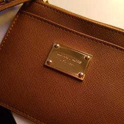 Brown with gold Michael kors logo , ideal for lose change and cards.