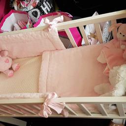 White crib with pink bedding included. Few minor marks but nothing major