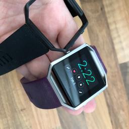 With purple and black strap and charger full working order