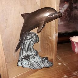 A lovely ornate vintage dolphin bookend/oranment. Carved in iron and handpainted.
