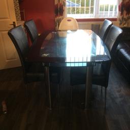 Glass table and 4 leather chairs few minor scratches on table no marks or rips on chairs good clean condition