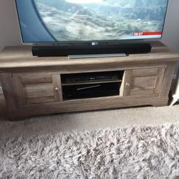 Realistic solid wood TV cabinet will fit large TV up to 65" 138cm wide x 43cm deep. 49" high. In as new condition only 6 months old. Also selling matching lamp table.