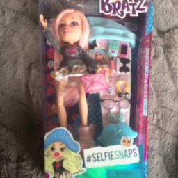 Bratz doll 
With little toys to dress the doll with. 
Never opened it