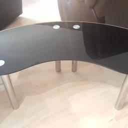 Stylish curved black glass coffee table,odd surface scratches as to be expected, overall good condition 
Roughly 
47" long 
18" high