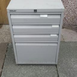 Old filing cabinet with 3 shallow traders and one feel drawer. Handy for garage or shed storage.