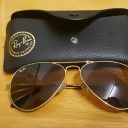 A genuine pair of mens rayban avator sunglasses for sale. Gold mental frames including dark brown glasses.

Description details: RB3025 Avator large mental 55014.

Vinage rayban but unsure of its age?Very good condition l. No flaws or defects. Eye glass perfect. Some slight scratching shown in photo on one of the earlops nothing major.

Also comes with genuine rayban case with black velvet interior.Some wear and tear of caseagain due to age but overall these raybans are if good quality.